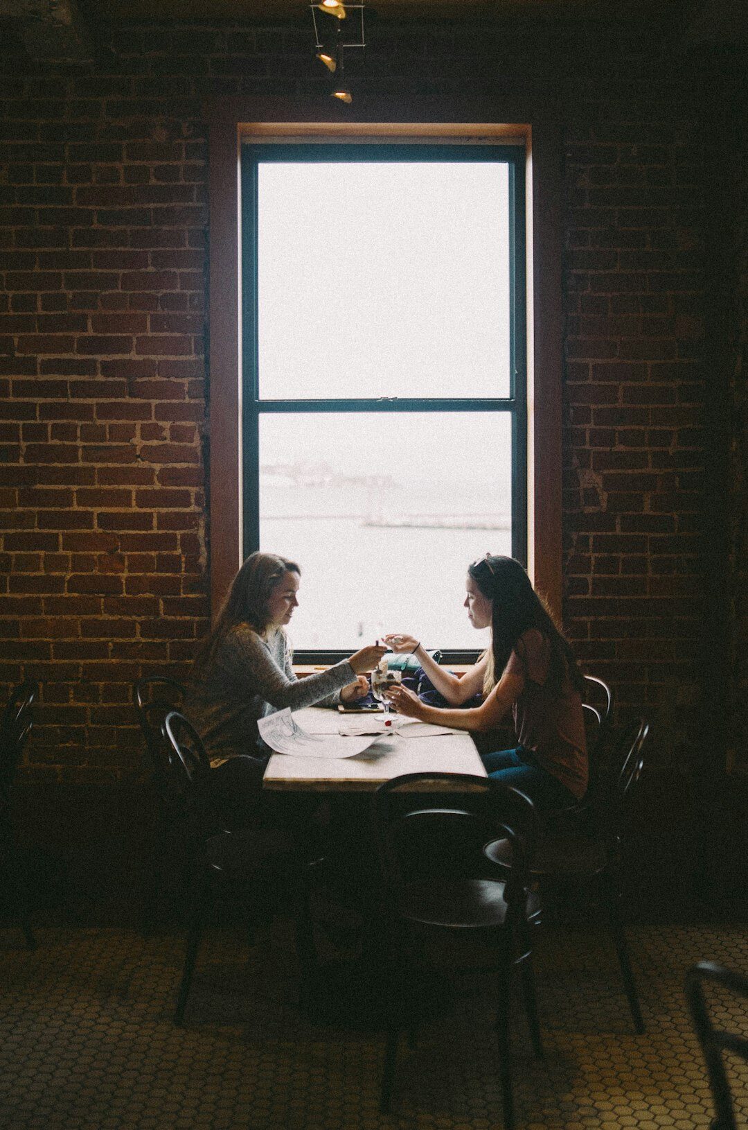 Two business professionals reviewing documents together in a modern office