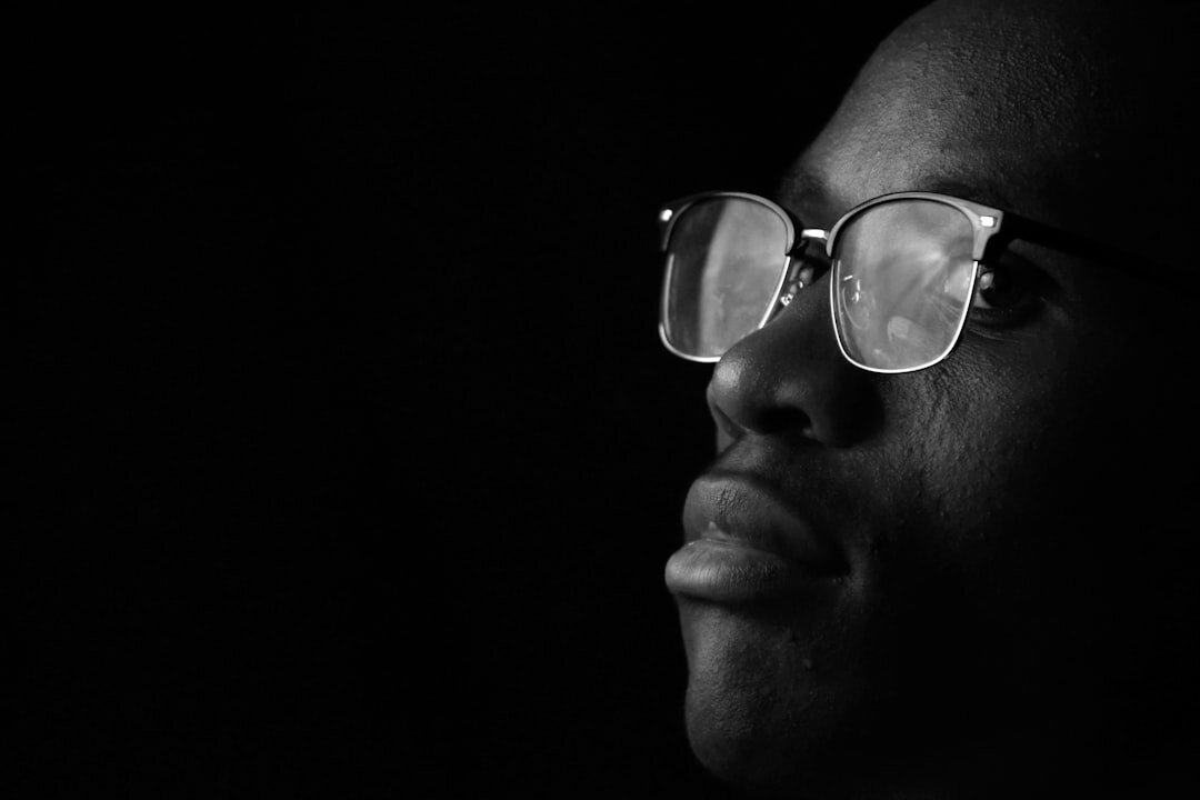 Studio portrait of a Black man in his 50s wearing glasses